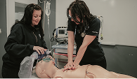 A Mosaic Medical instructor teaching a medic how to perform CPR.
